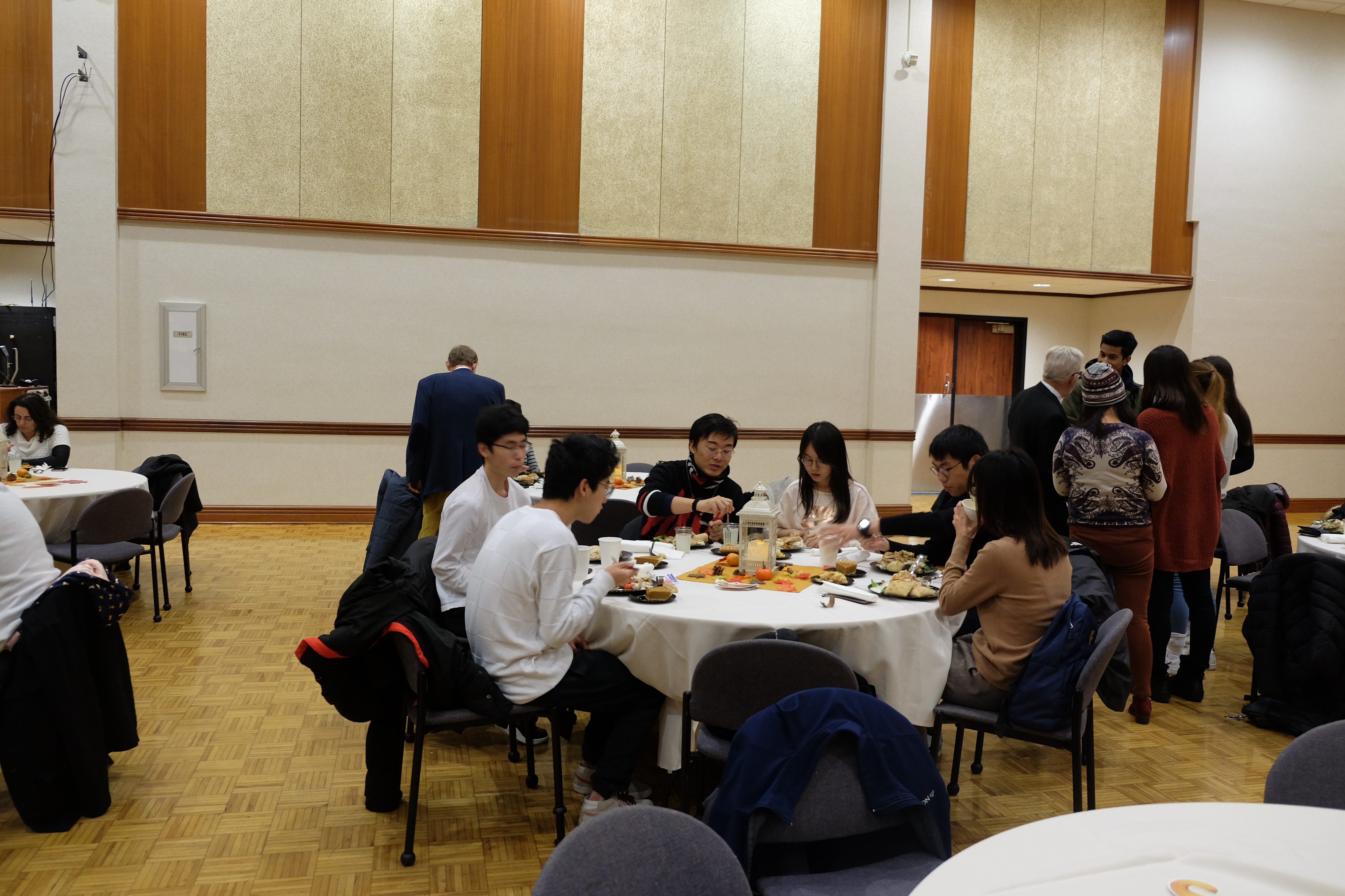 People sitting at a table and dining at the American Thanksgiving event 2019